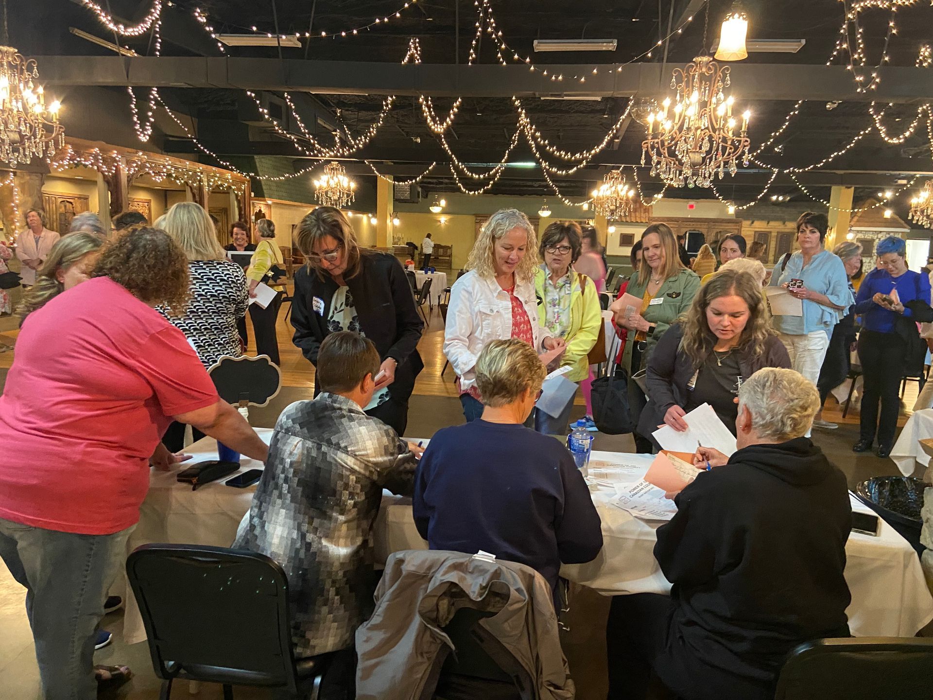 A group of people are sitting around a table in a room.
