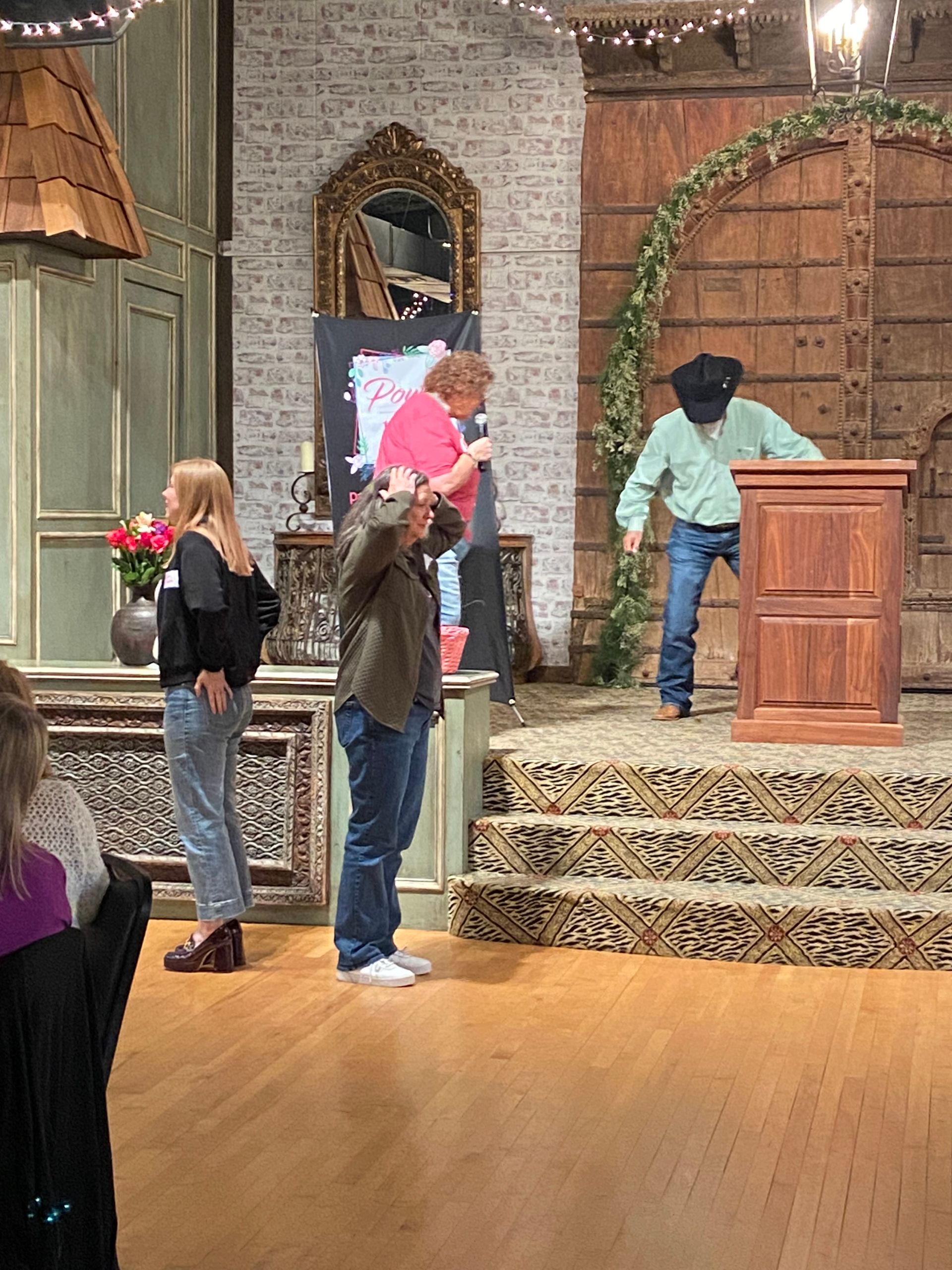 A group of people standing around a podium in a room.