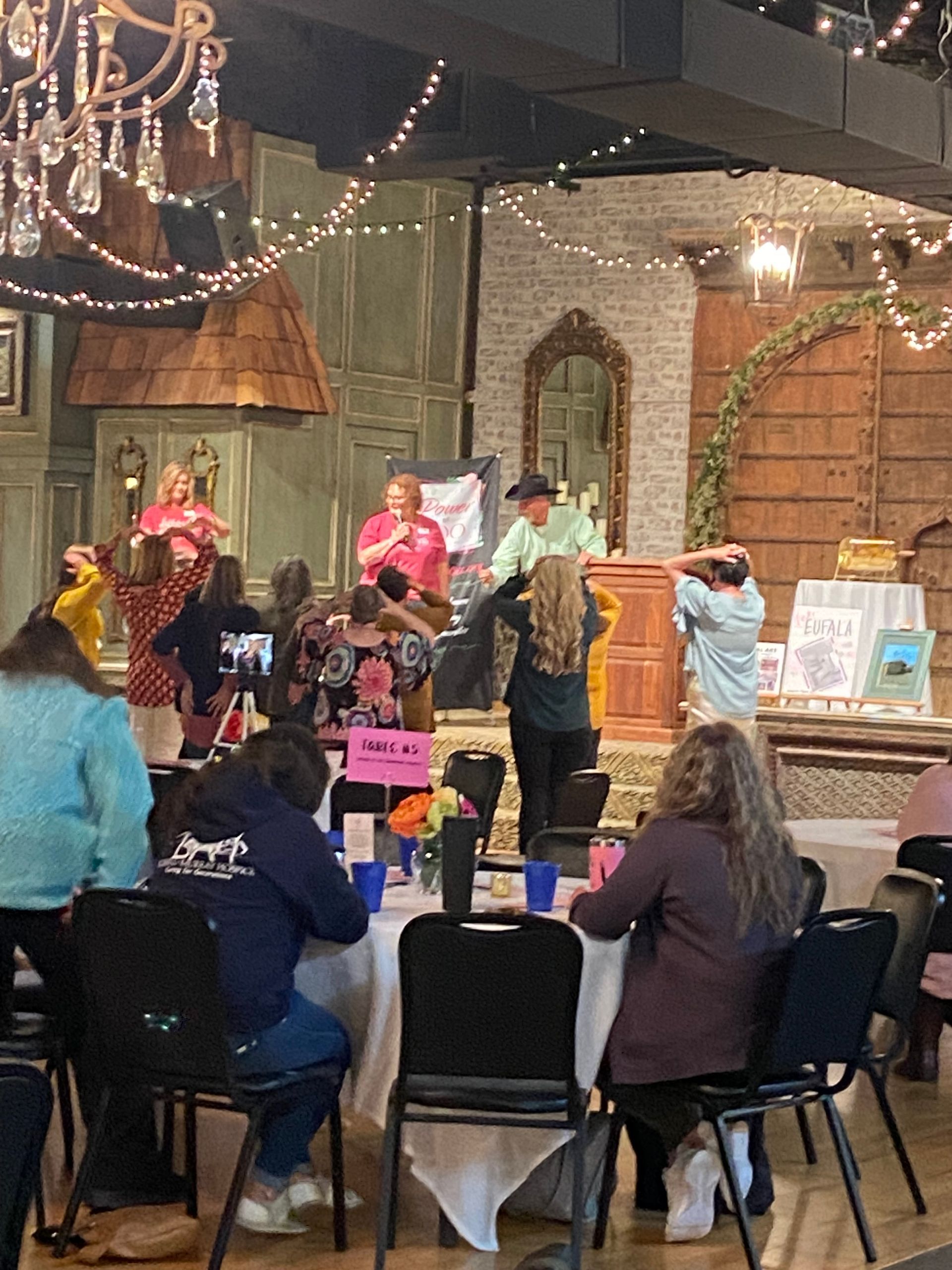 A group of people are sitting at tables in a room.
