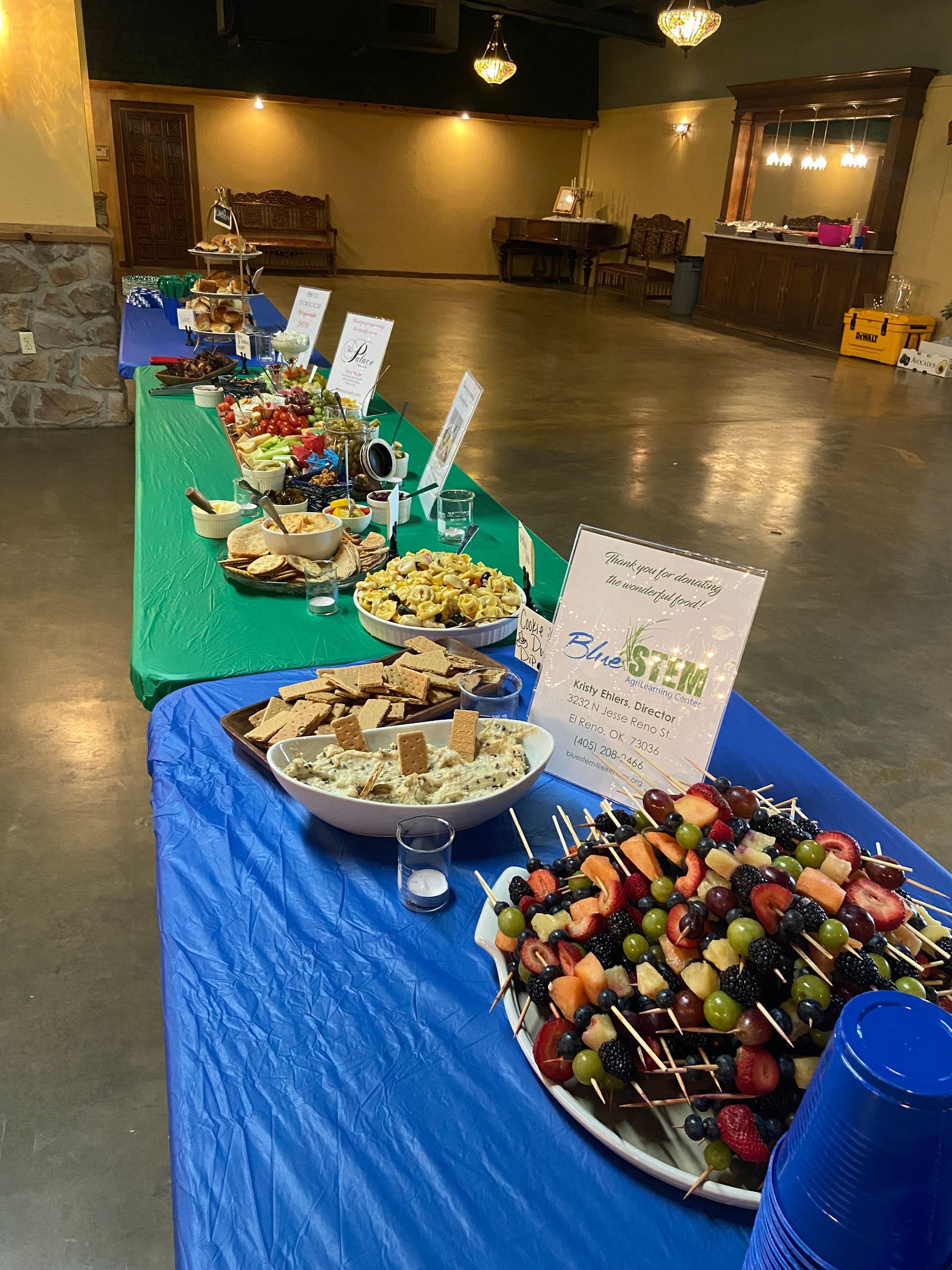 A long table with plates of food on it in a room.