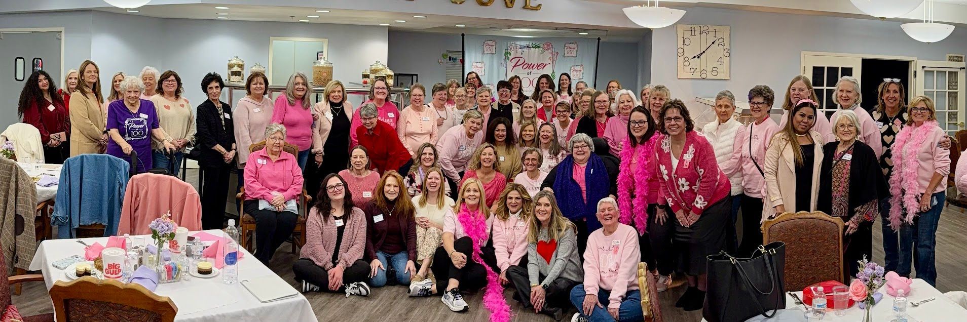 A large group of people are posing for a picture in a room.