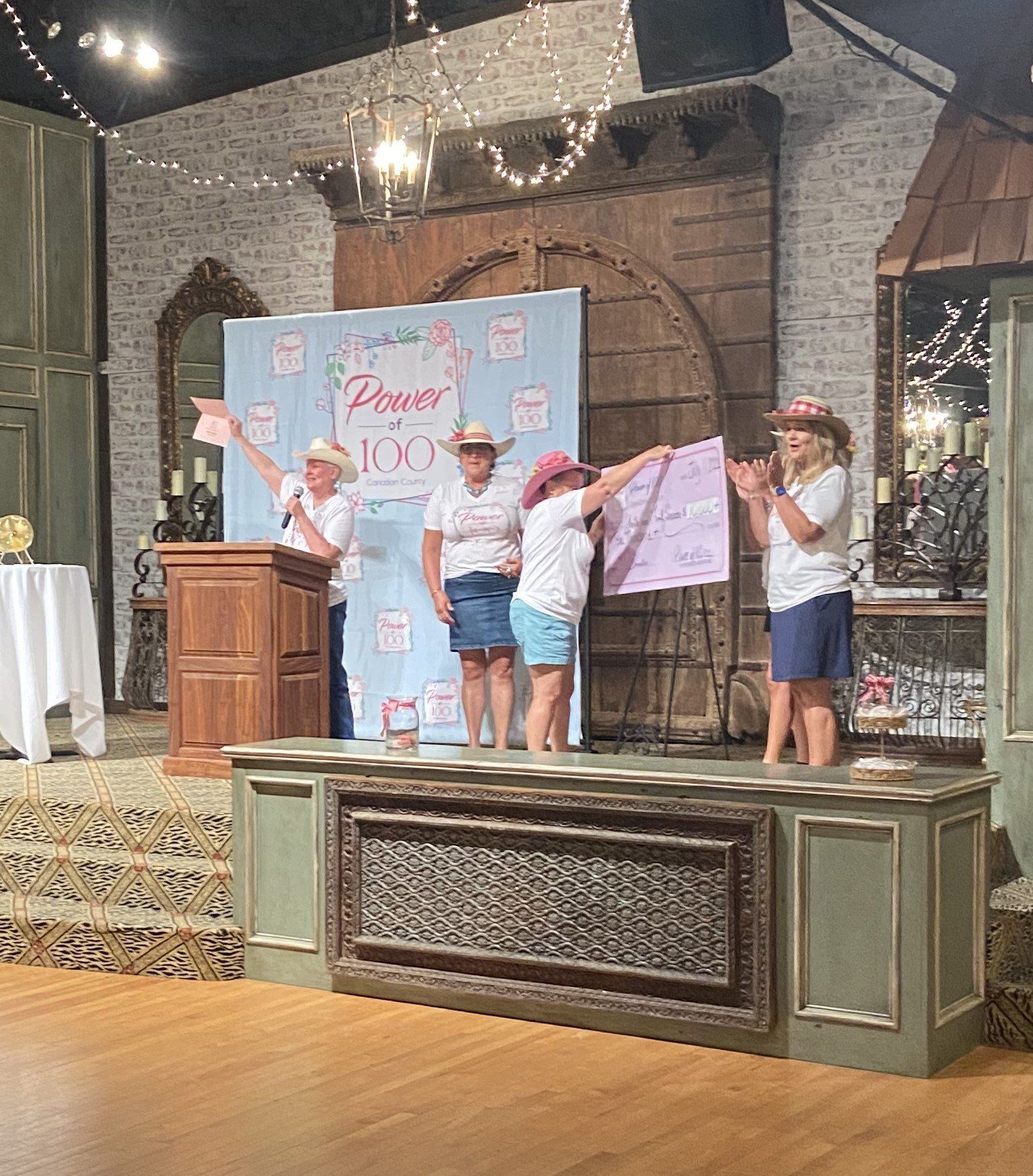 A group of women are standing in front of a podium holding signs.