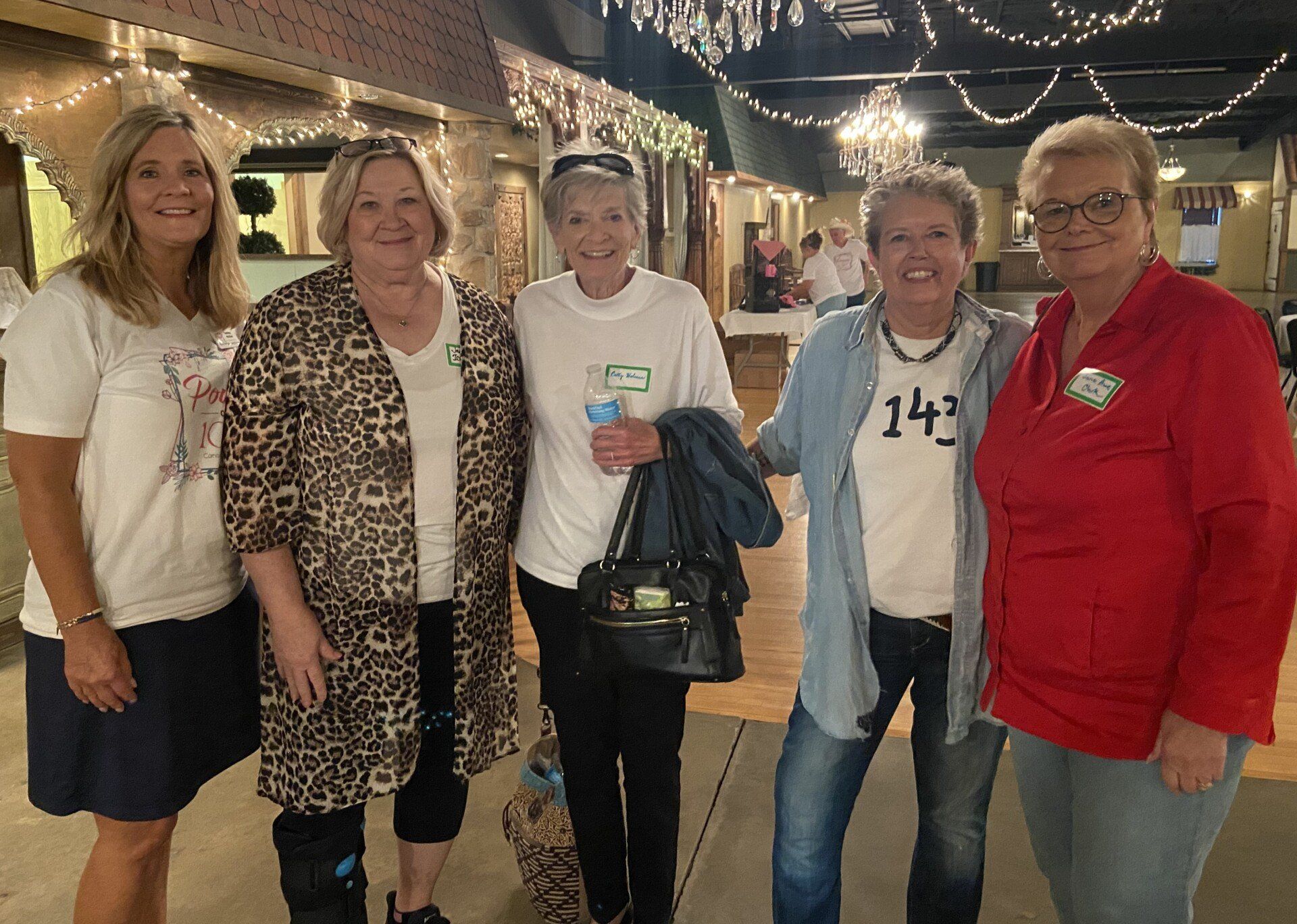 A group of women are posing for a picture in a room.