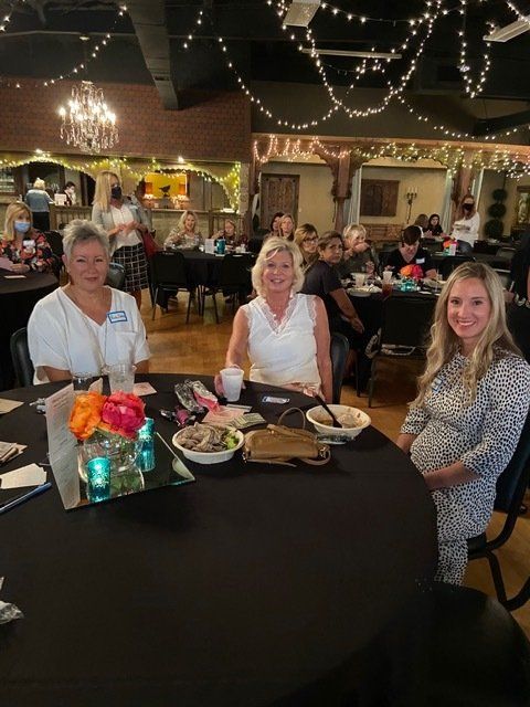 A group of women are sitting at a table in a restaurant.