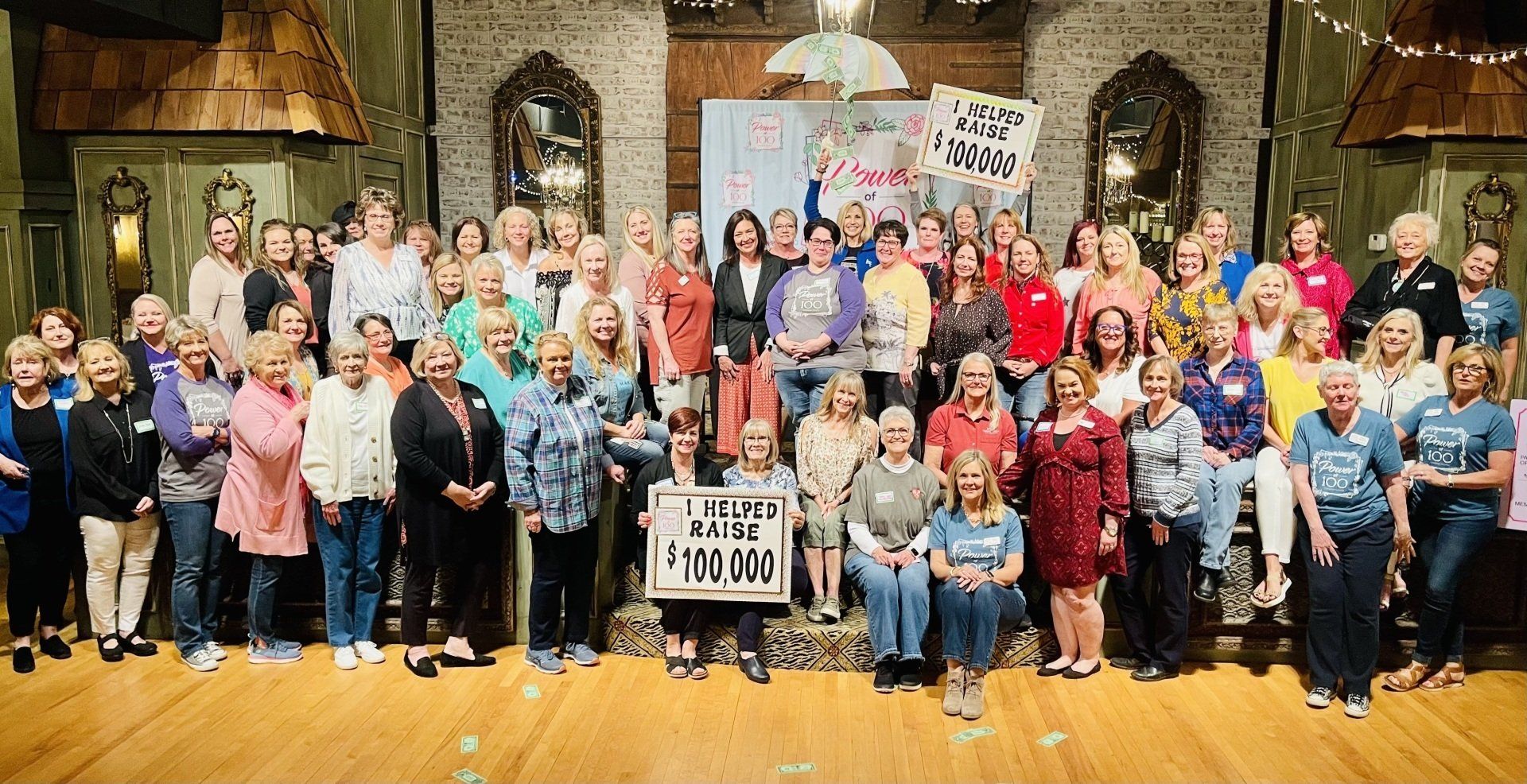 A large group of people are posing for a picture in a room.