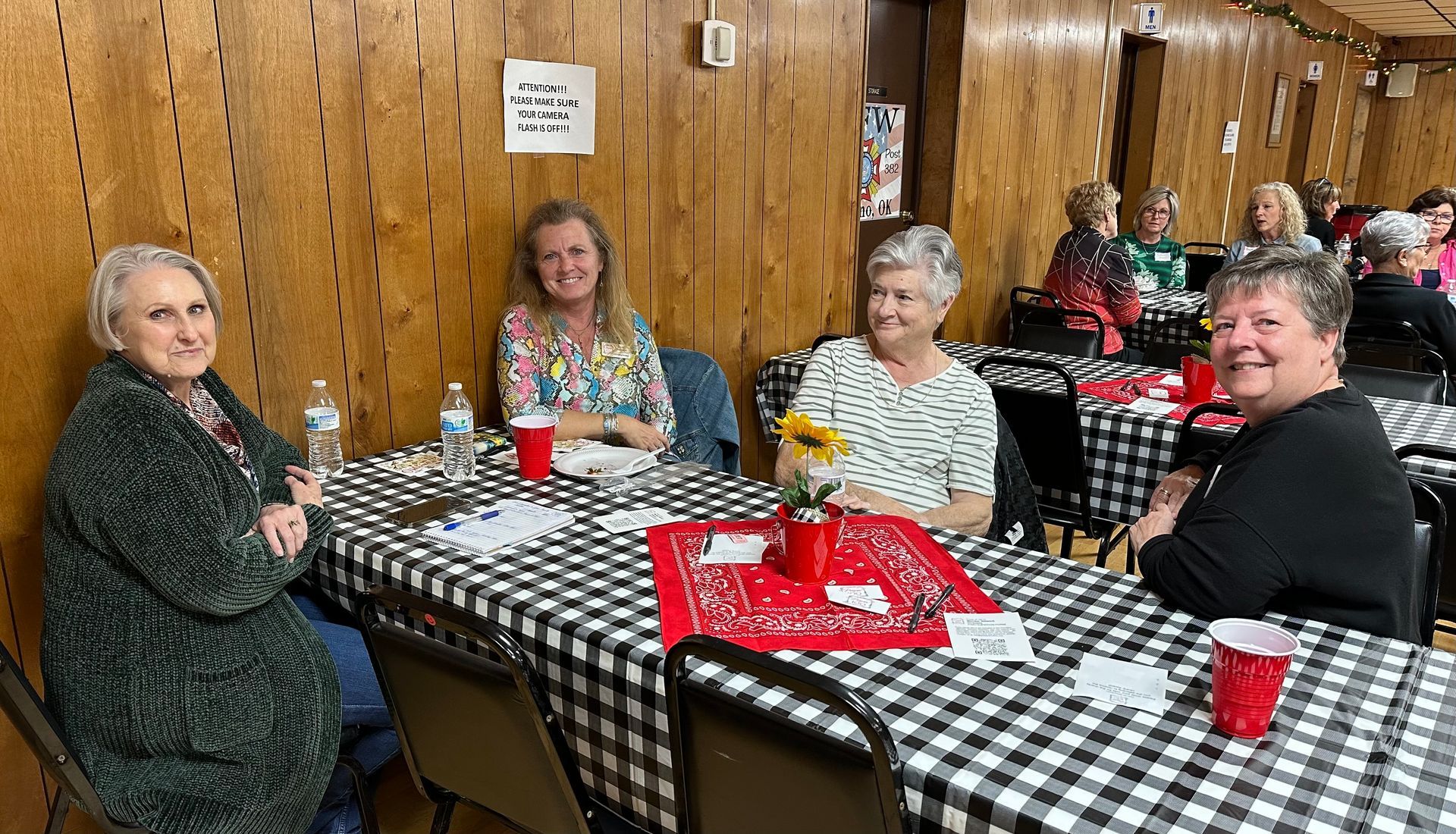 A group of women are sitting at tables in a room.