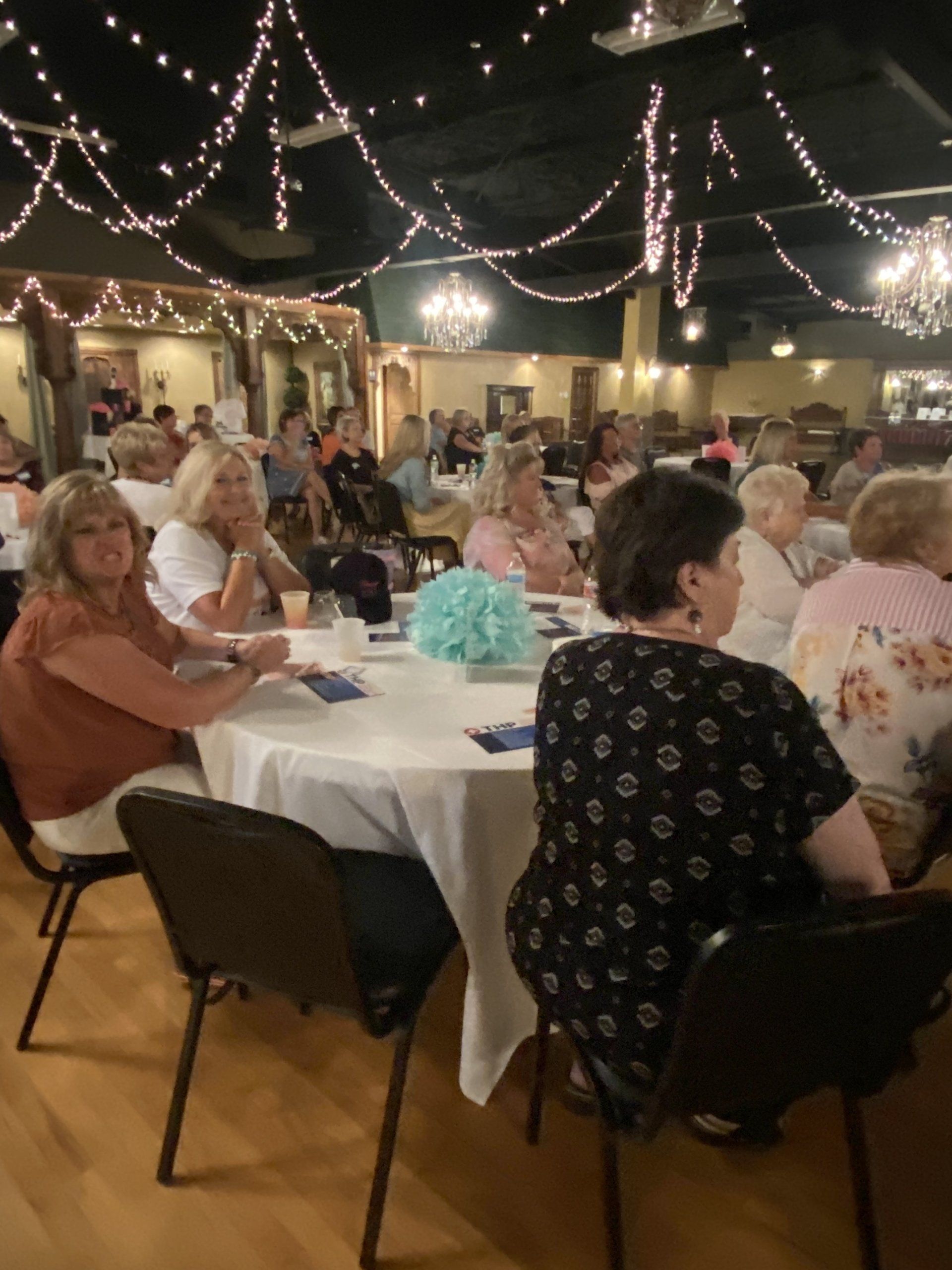 A group of people are sitting at tables in a room