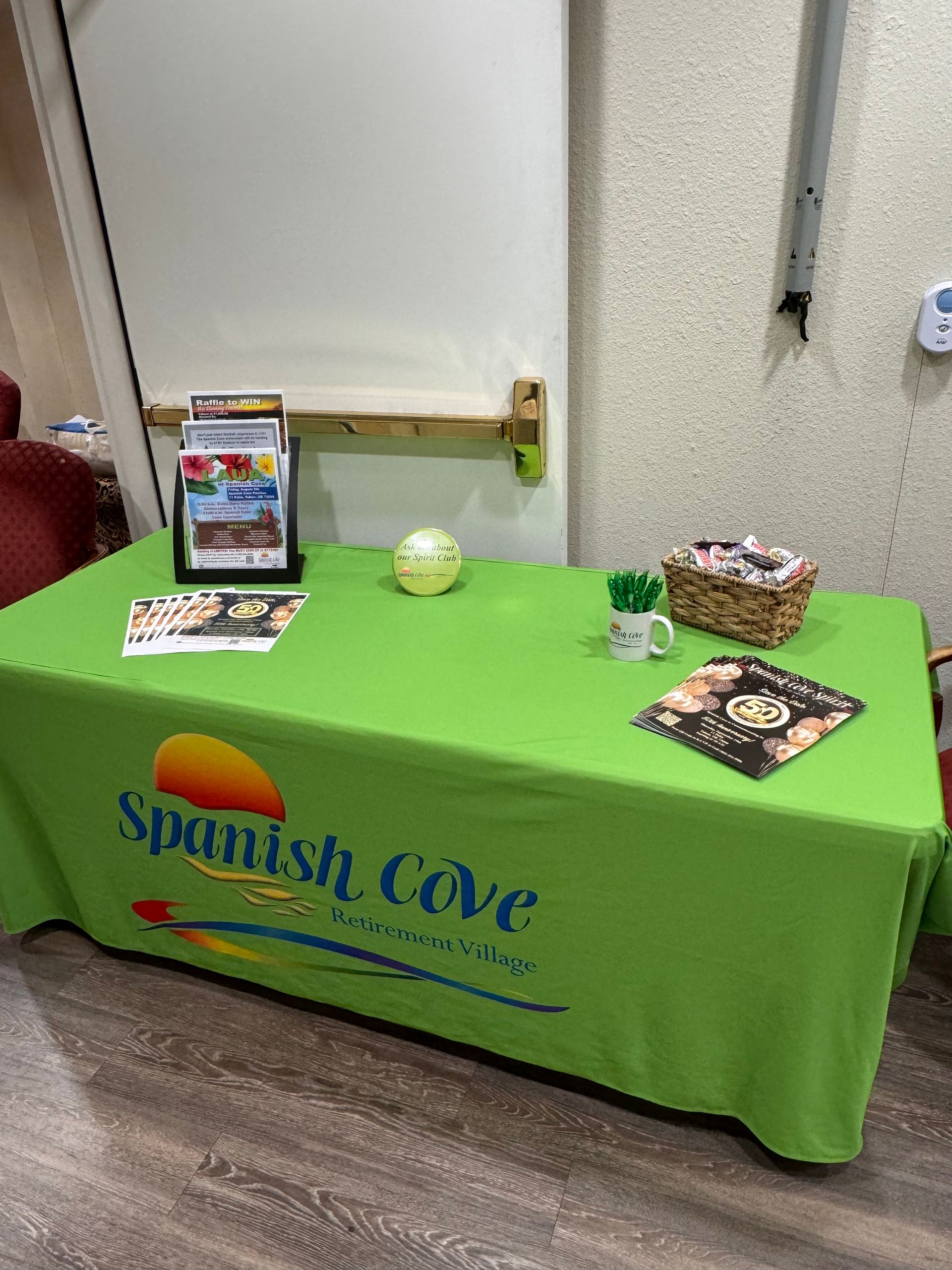 A green table cloth with spanish cove written on it