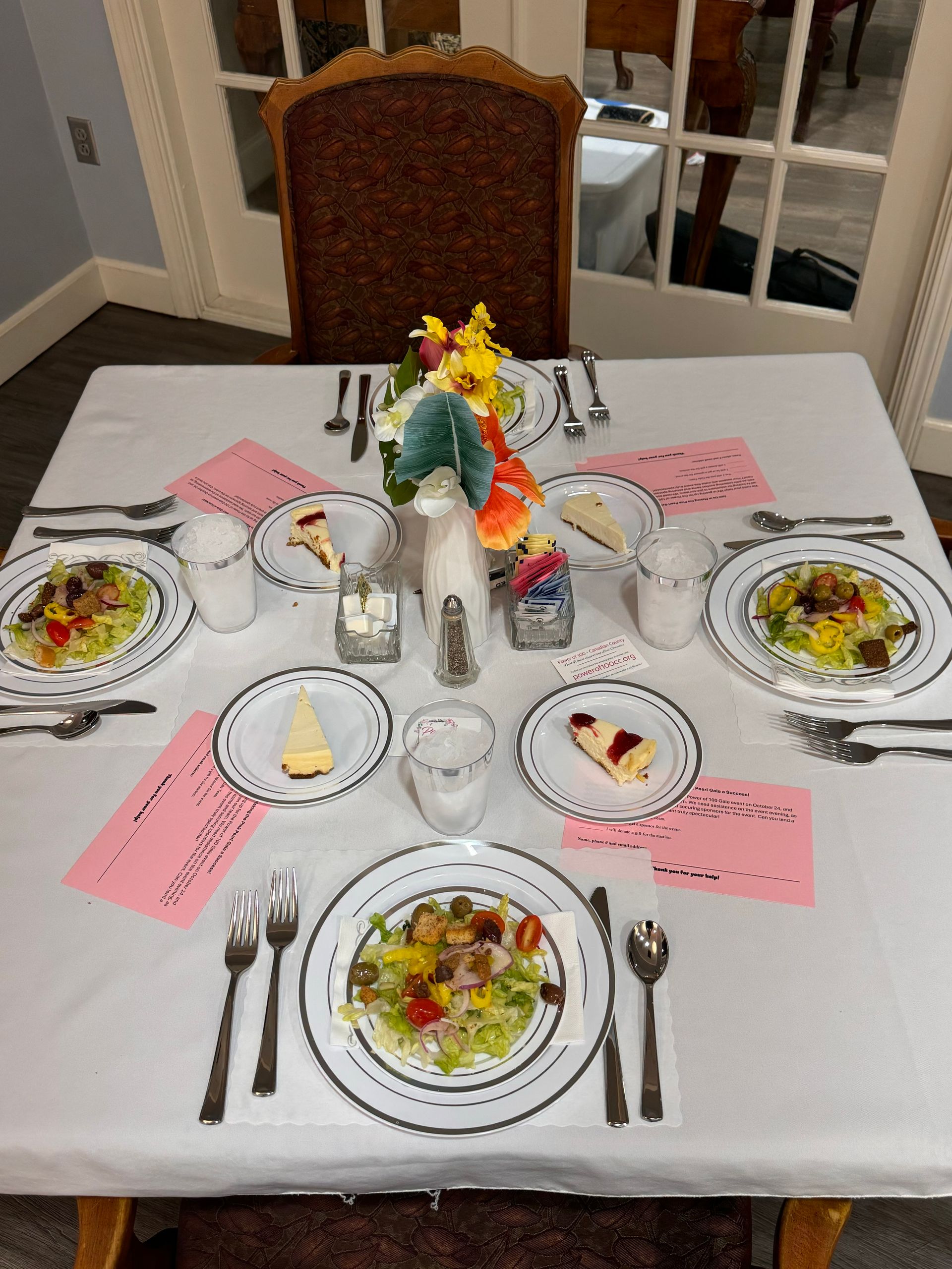A table with plates of food and silverware on it