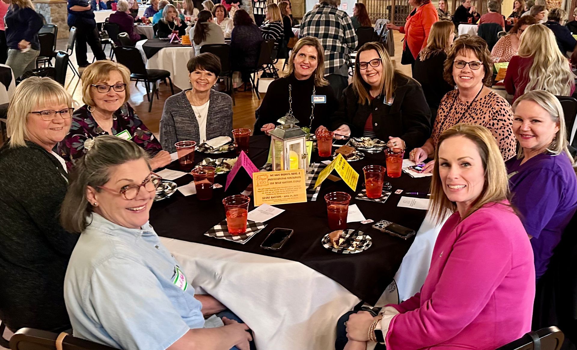 A group of women are sitting at a table in a restaurant.