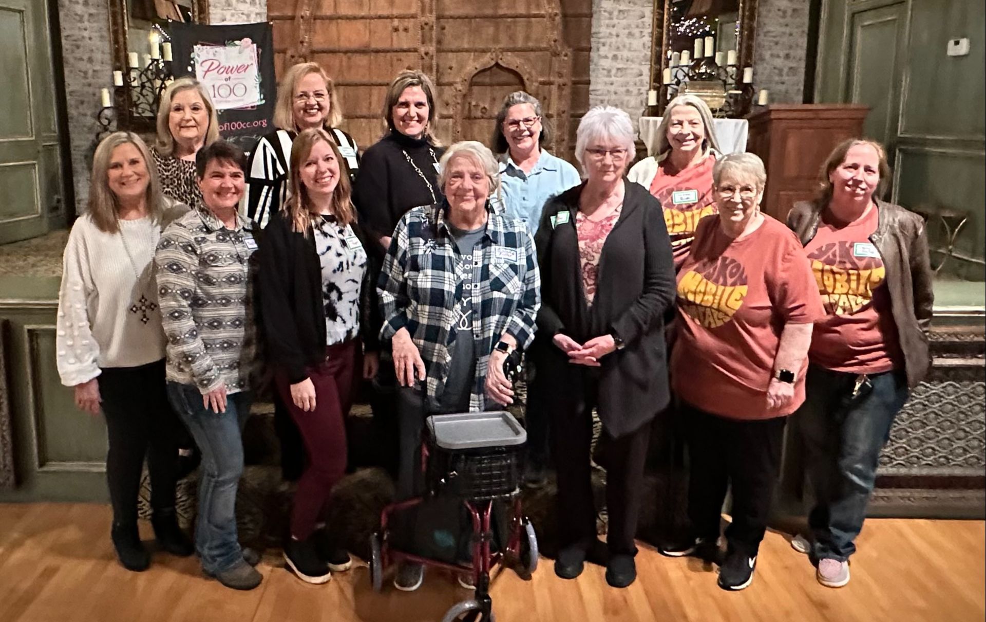 A group of women are posing for a picture together in a room.