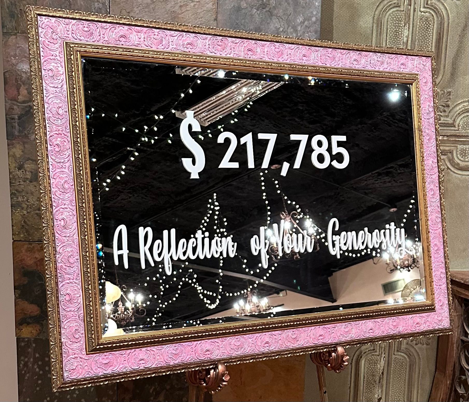 A mirror with a pink frame says a reflection of your generosity