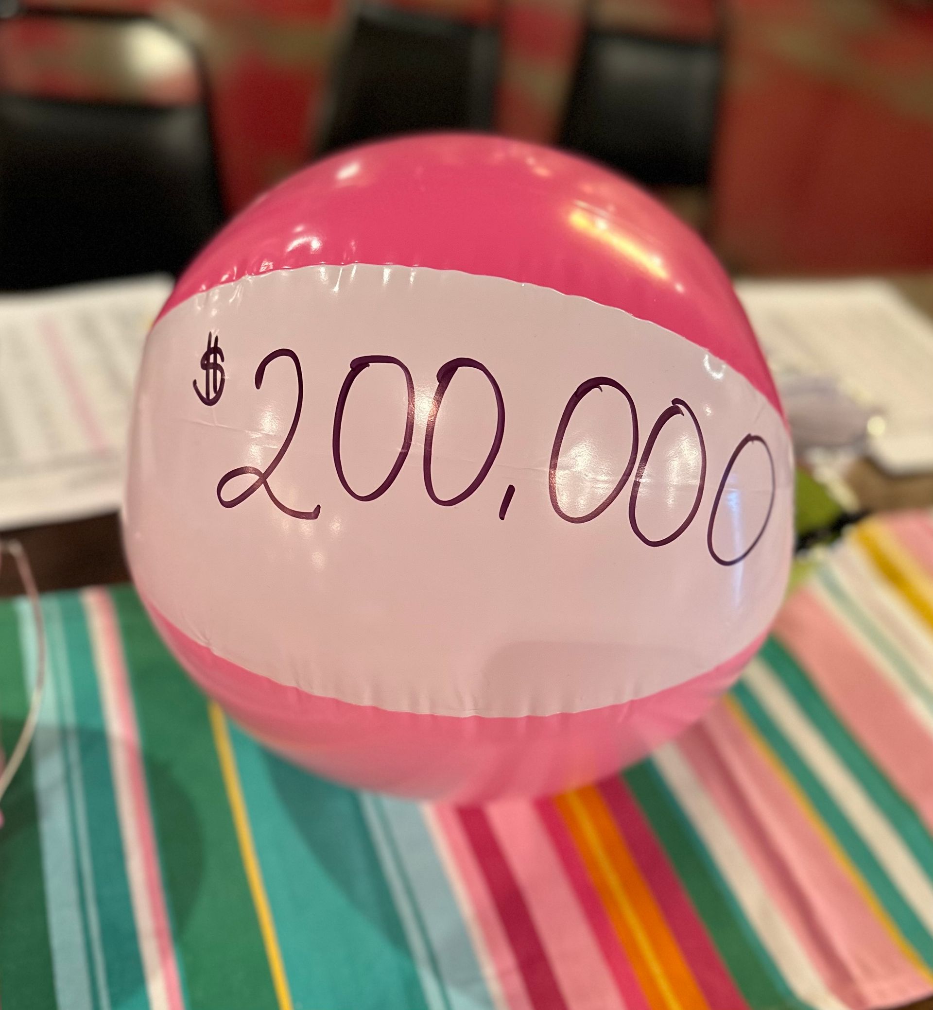 A pink beach ball with $ 200,000 written on it