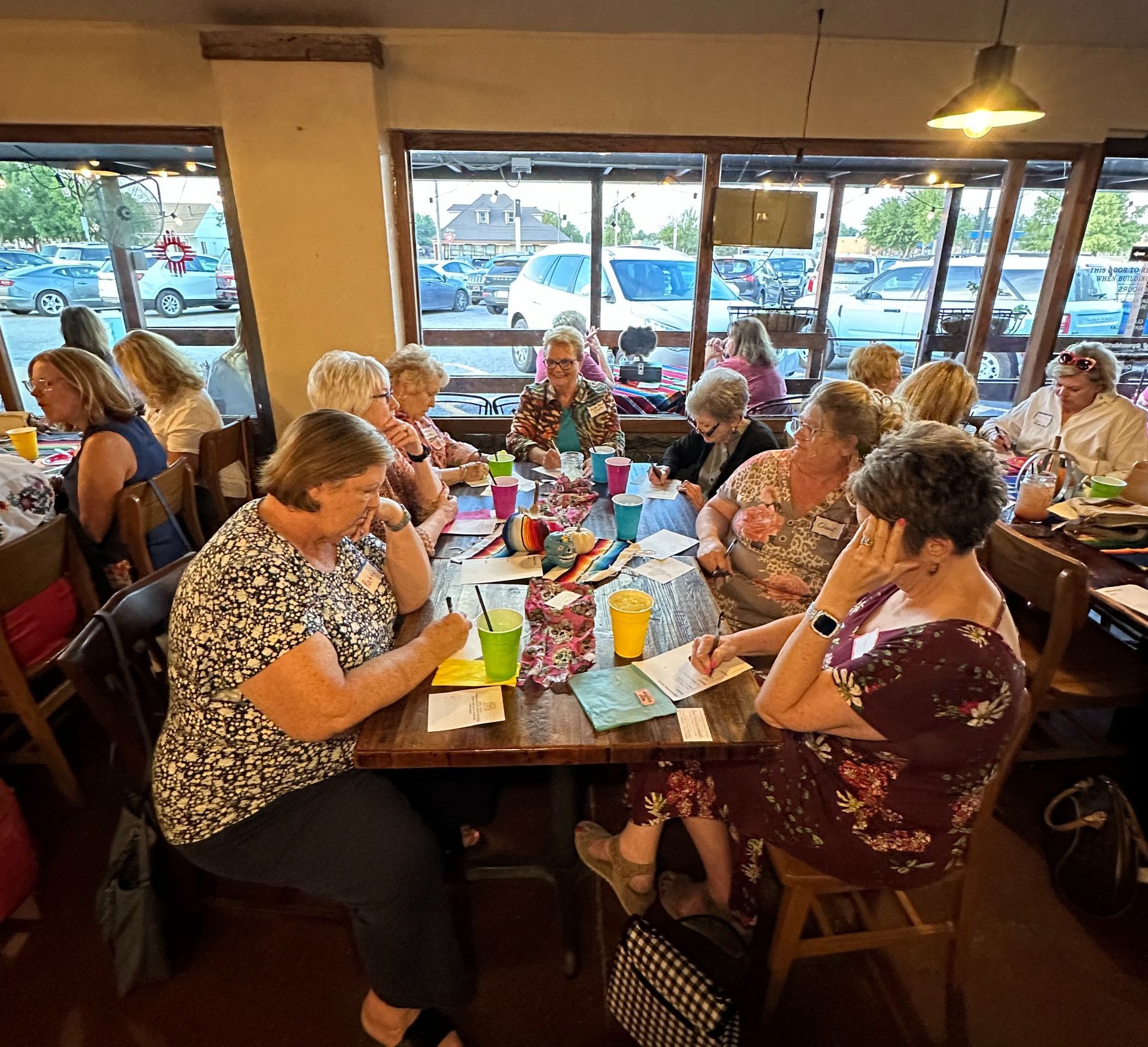 A group of people are sitting at tables in a restaurant.