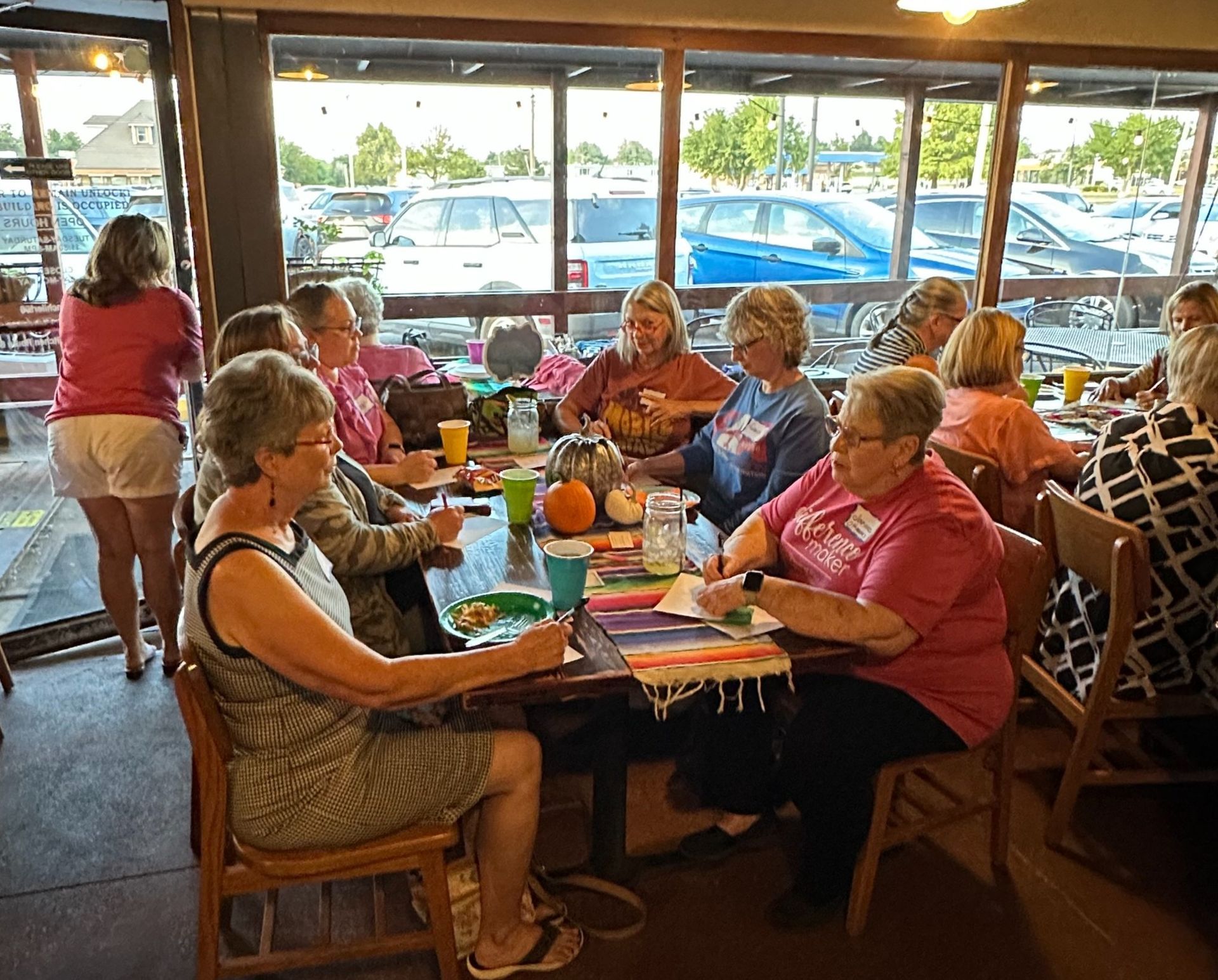 A group of women are sitting at a table in a restaurant.