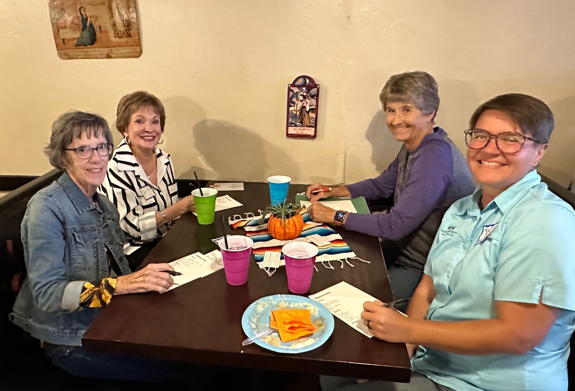 A group of women are sitting at a table in a restaurant.