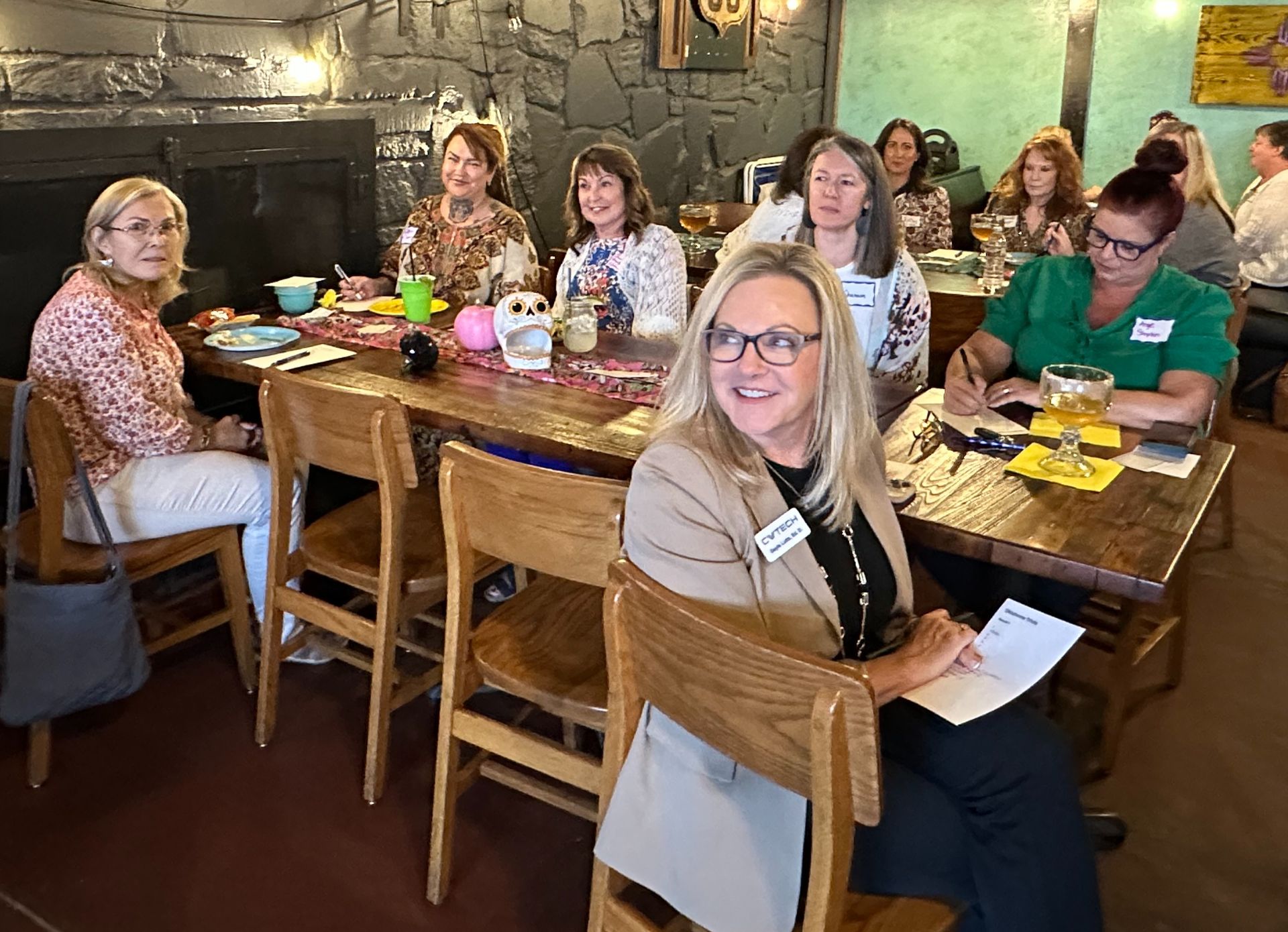 A group of women are sitting at a table in a restaurant.