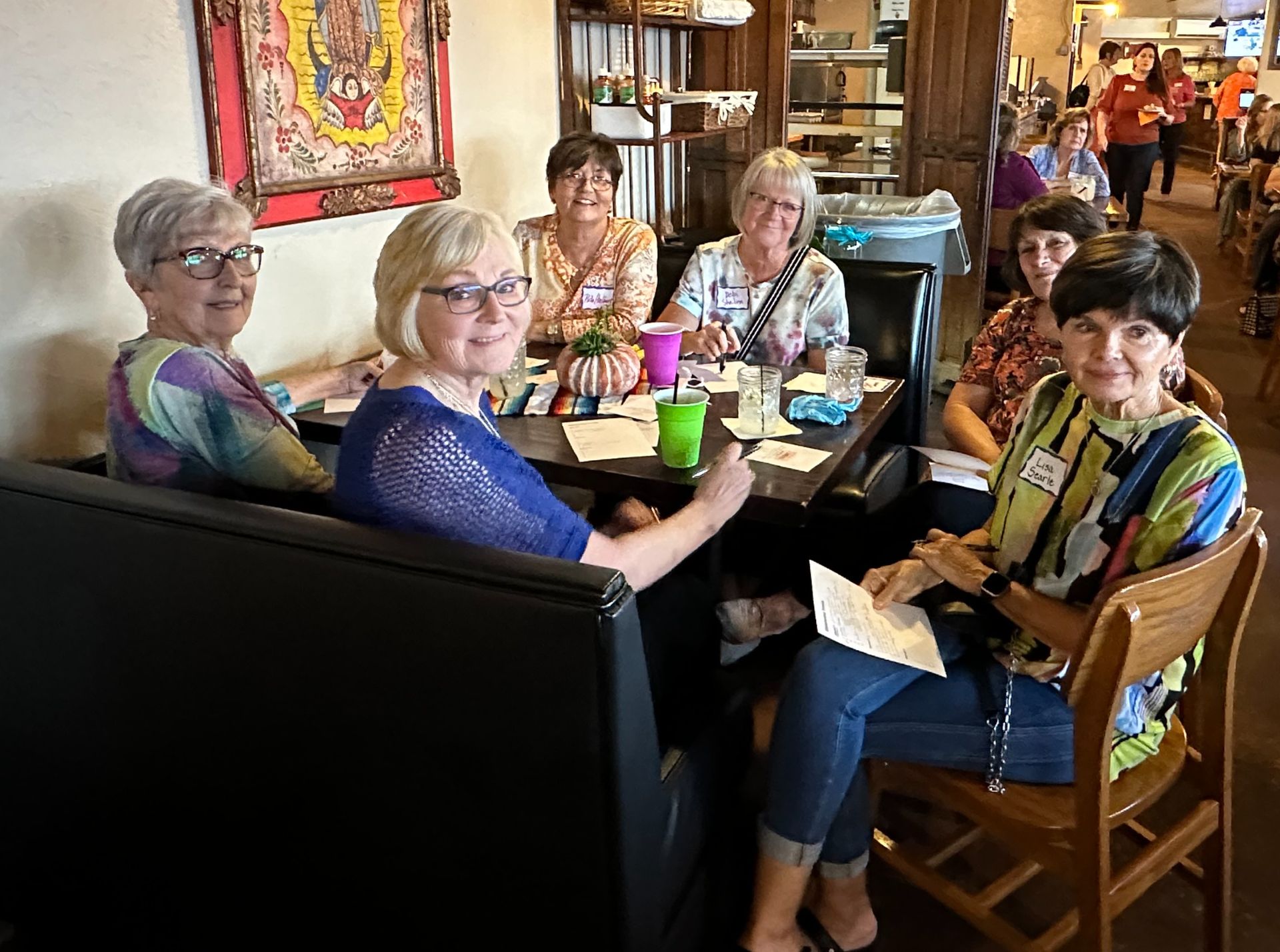 A group of women are sitting at a table in a restaurant.