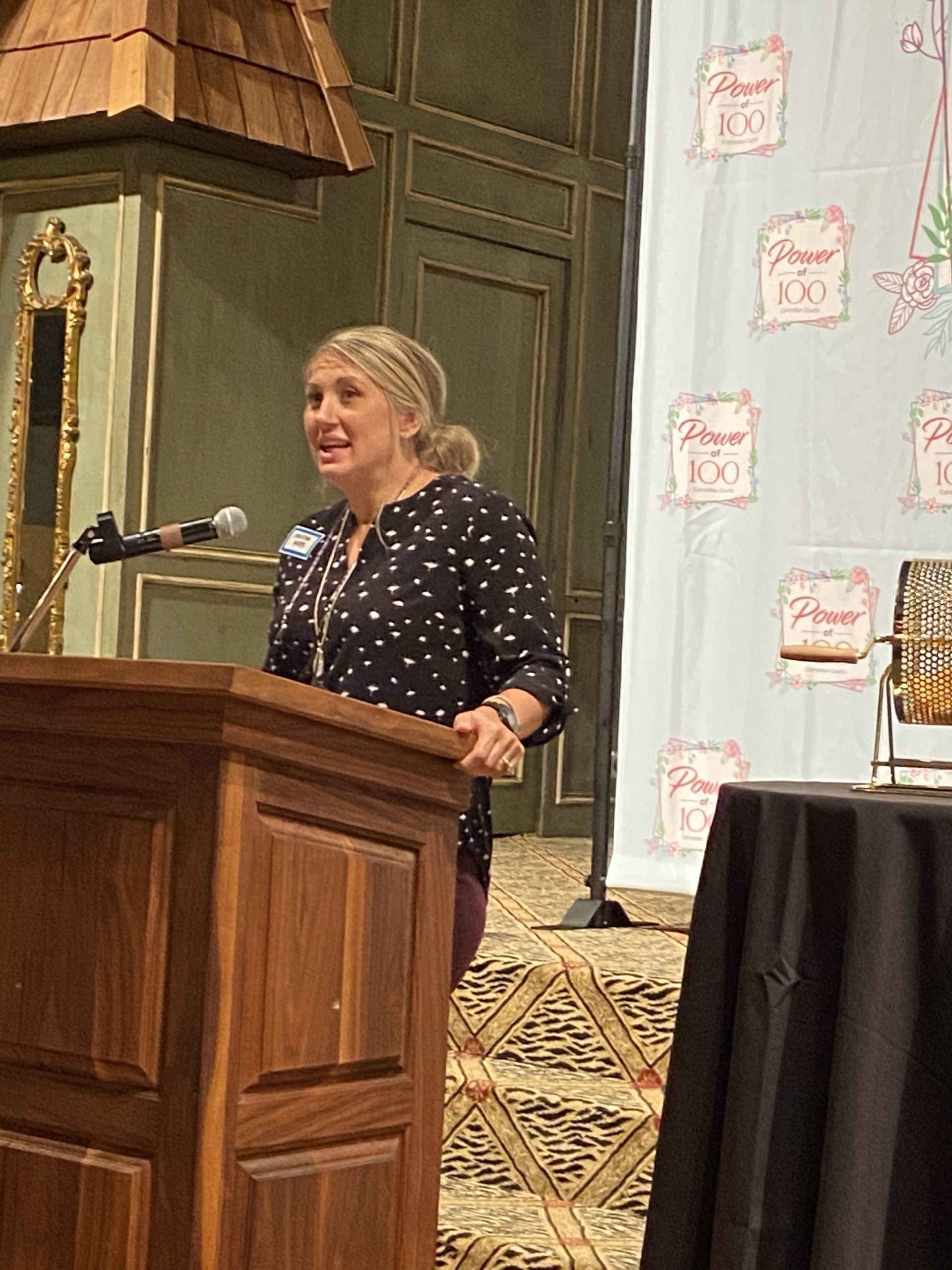 A woman is standing at a podium giving a speech