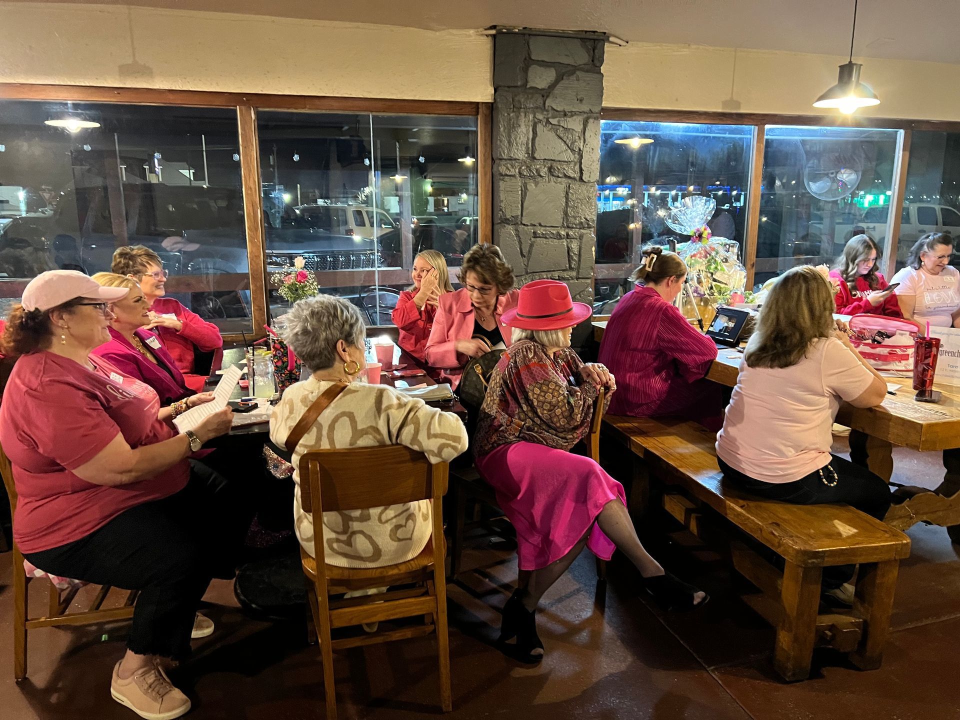 A group of women are sitting at tables in a restaurant.
