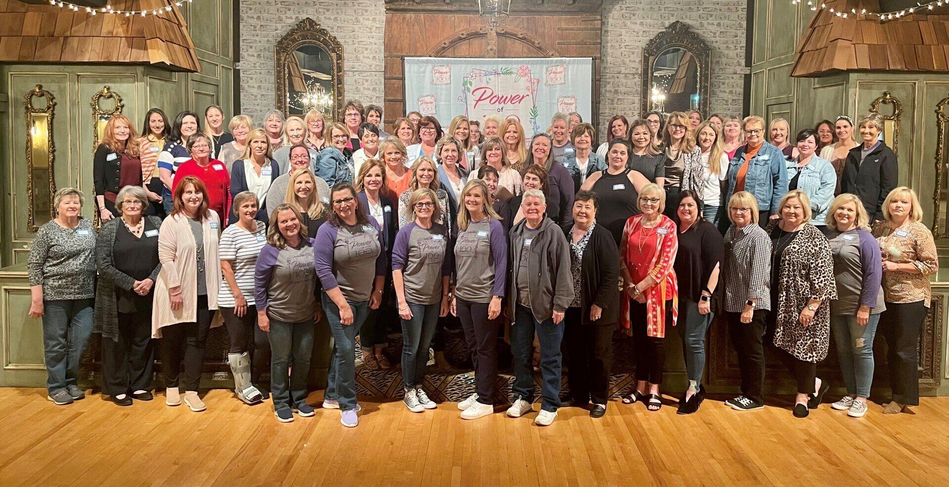 A large group of people are posing for a picture in a room.