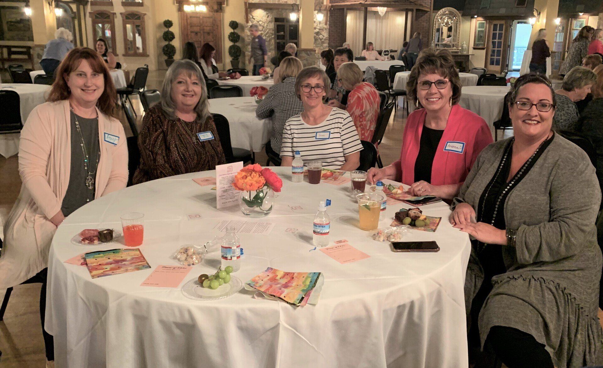 A group of women are sitting at a table in a restaurant.