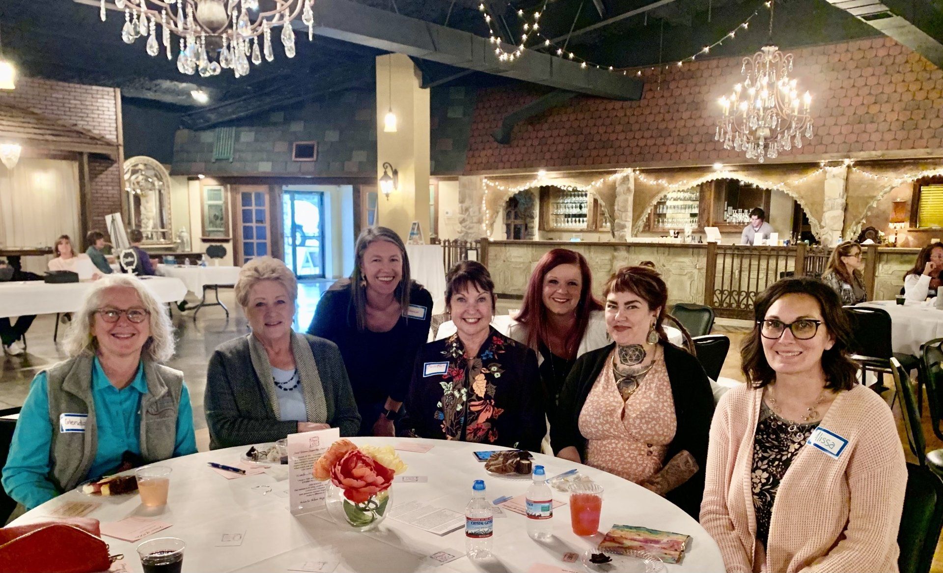 A group of women are sitting at a table in a restaurant.