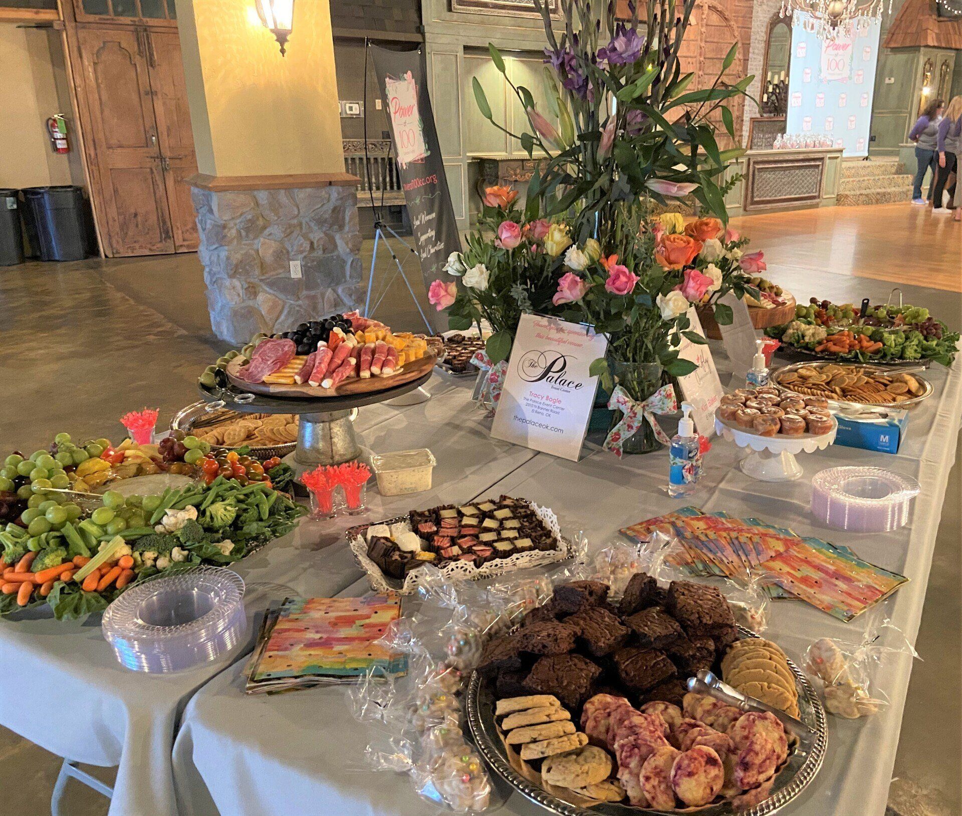 A table topped with plates of food and flowers.