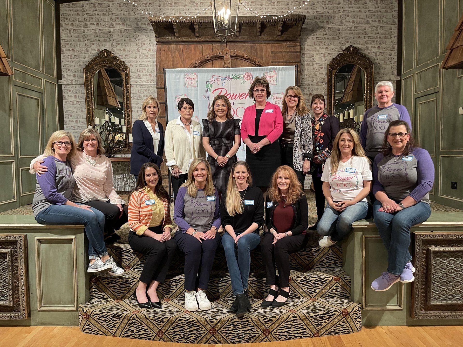 A group of women are posing for a picture in a room.