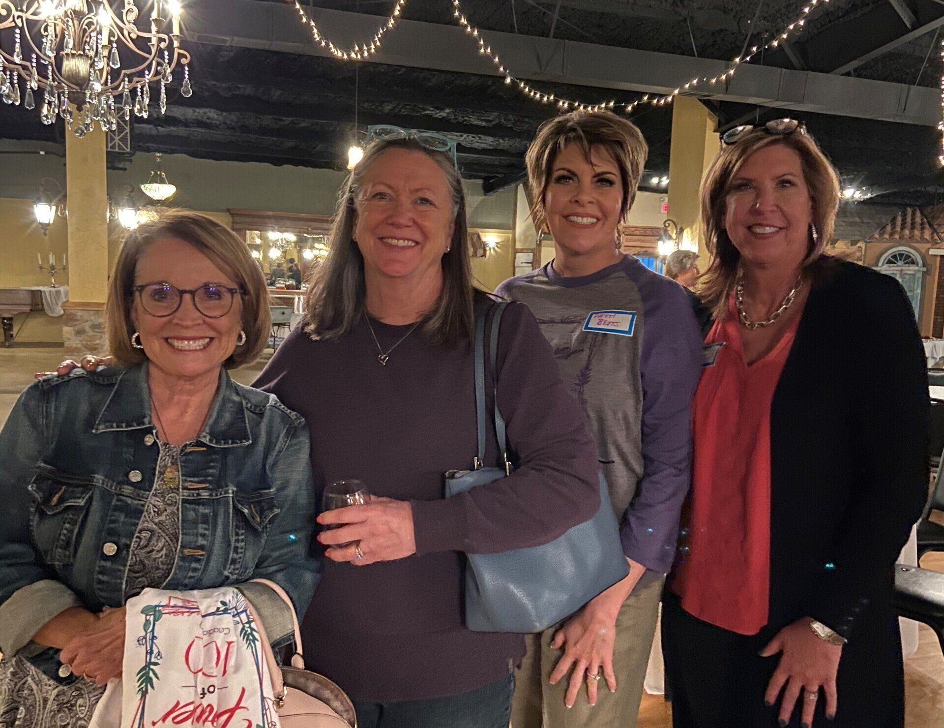 A group of women are posing for a picture in a restaurant.