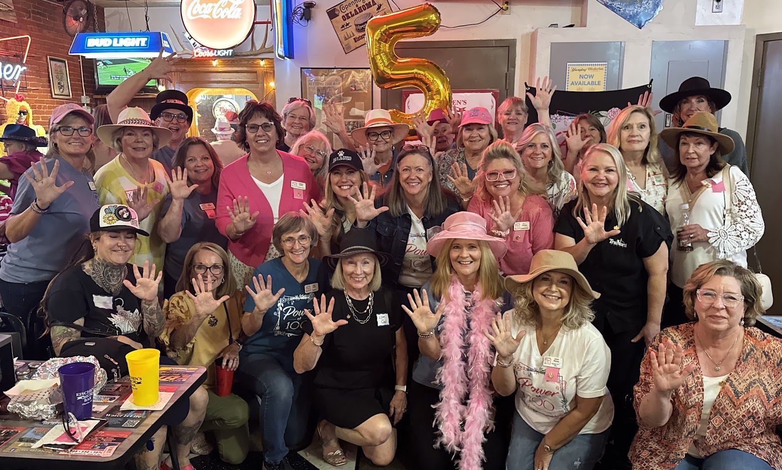 A large group of people are posing for a picture in a room.