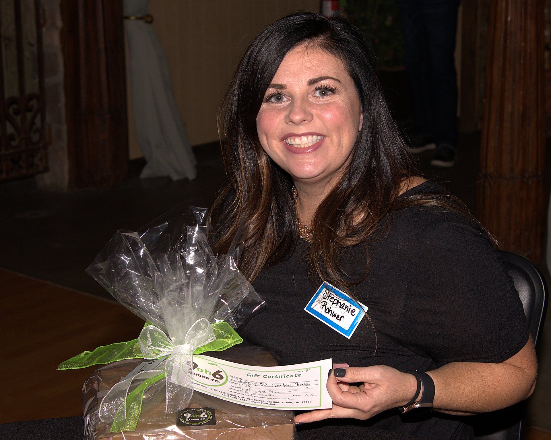 A woman with a name tag that says ' winner ' on it