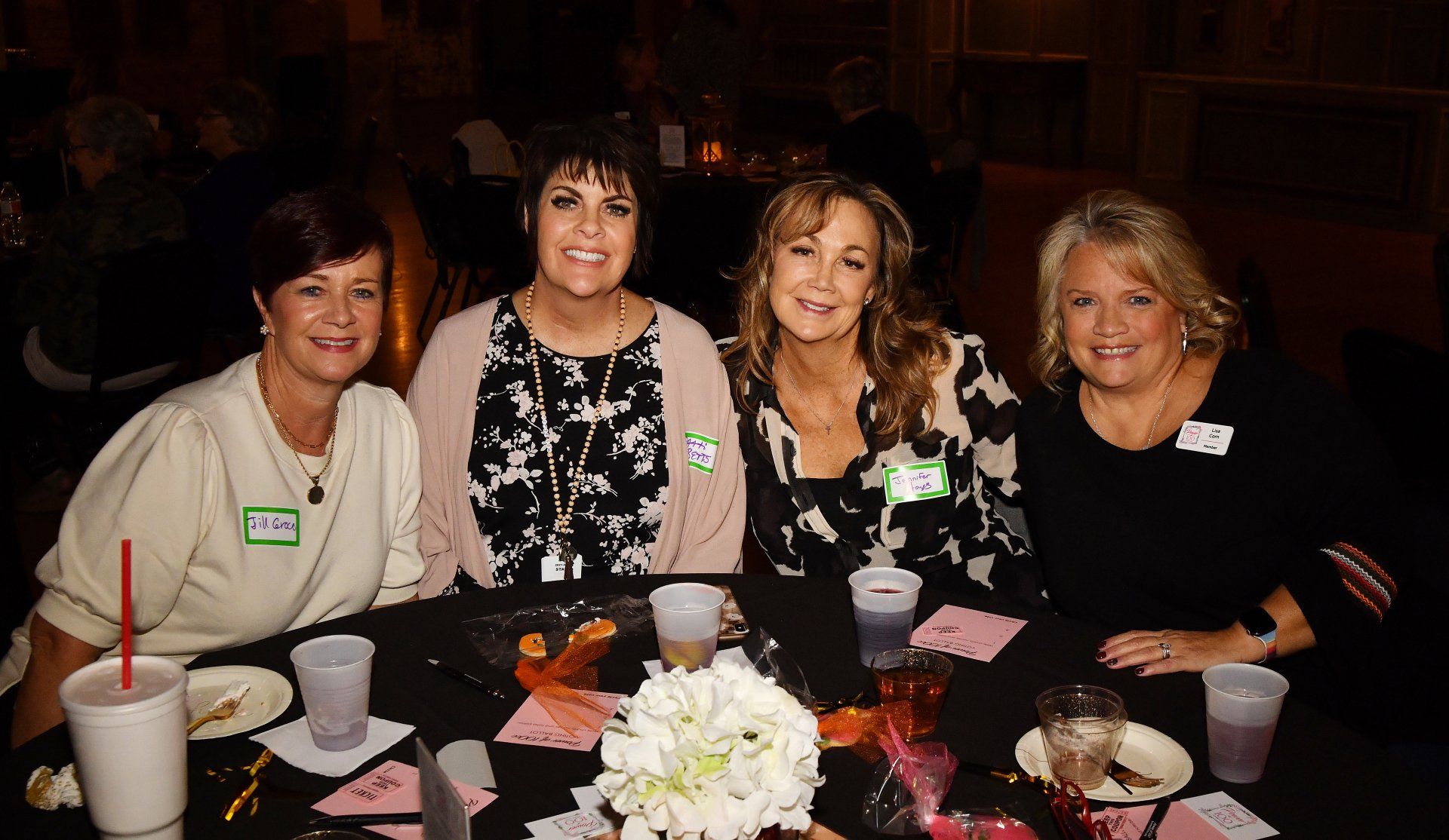 A group of women are sitting at a table with drinks.