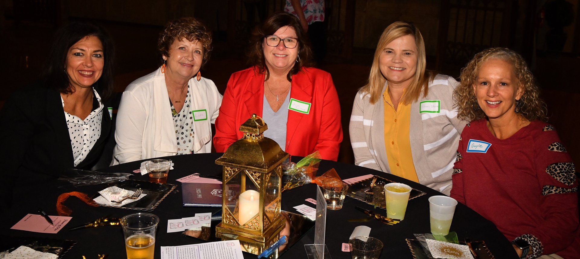 A group of women are sitting at a table with drinks.