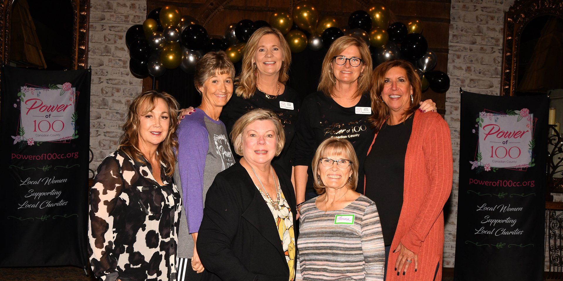 A group of women are posing for a picture together.