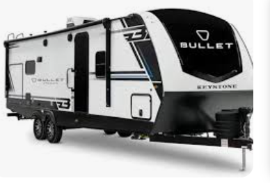 Black and white Keystone Bullet travel trailer with dual axles and front hitch on a white background