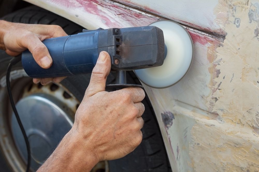 A Person Is Polishing A Car With A Machine — Lyons Street Paint Panel in Redlynch, QLD