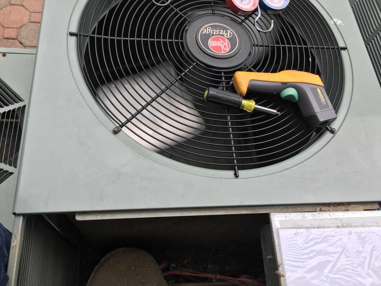 A fan with a screwdriver on top of it
