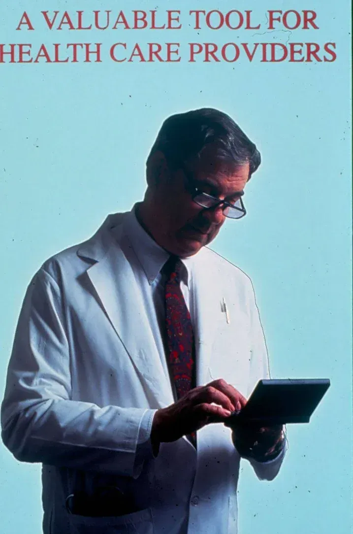 A man in a lab coat is looking at a tablet with the words 