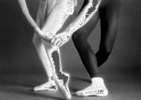 A black and white photo of two ballerinas dancing