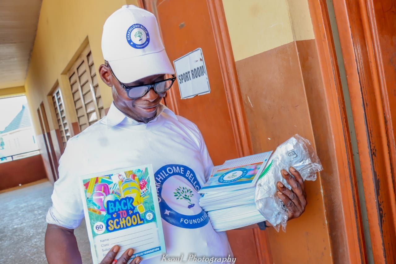 a man in a white shirt is holding a book .