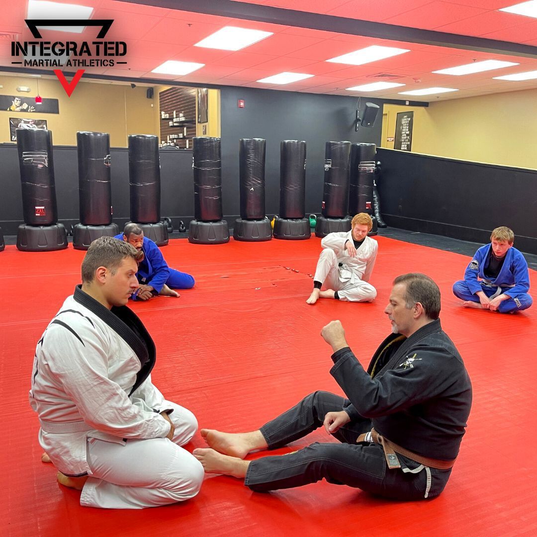 A group of men are practicing martial arts in an integrated martial arts gym