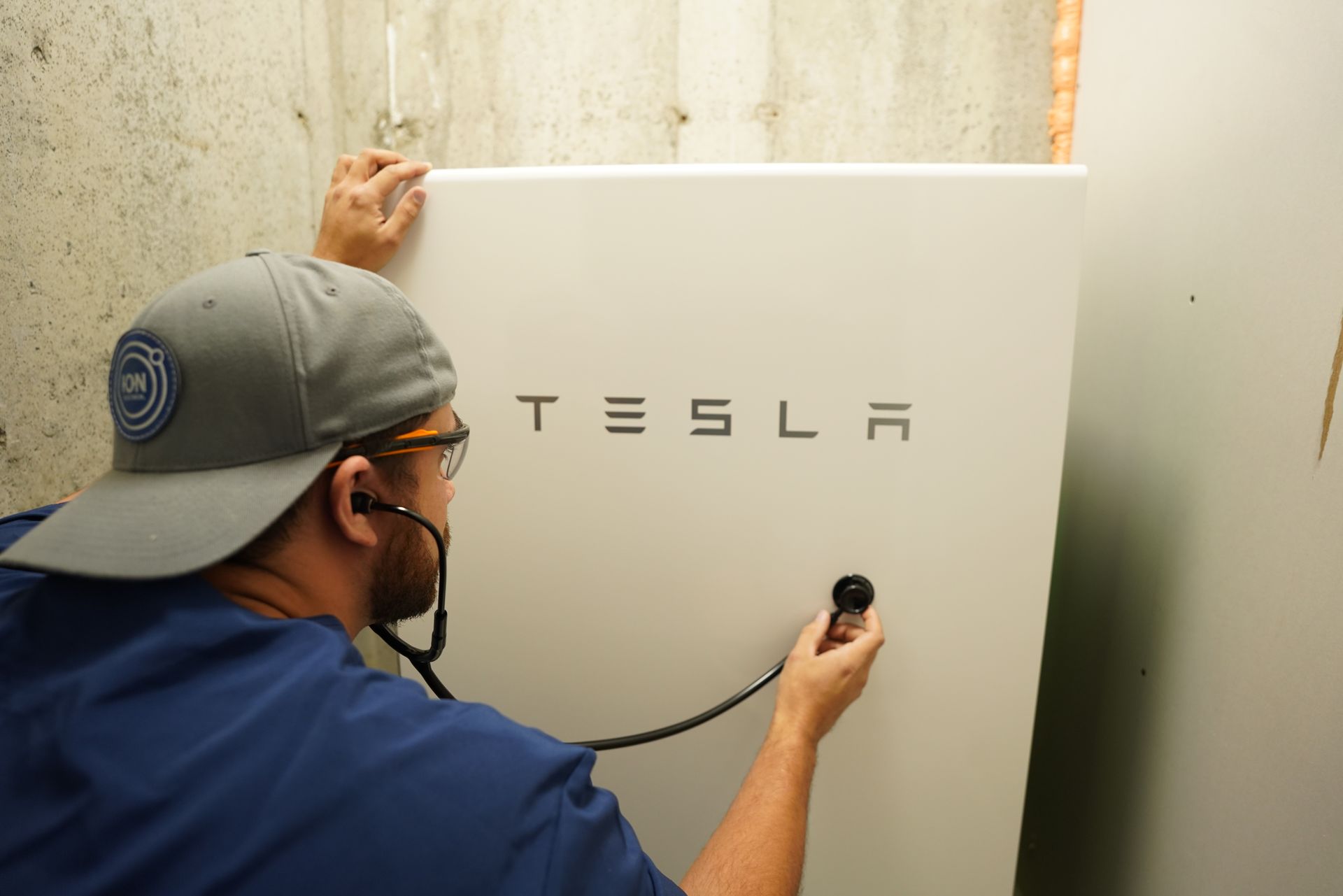 a man is working on a powerwall.