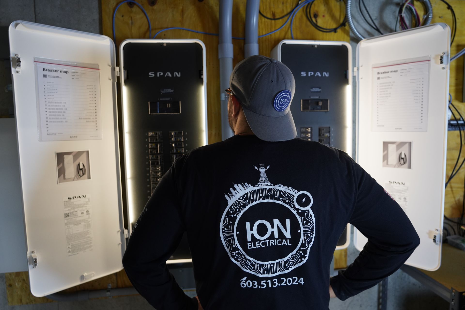 a close up of a electrical panel with a lot of wires coming out of it .