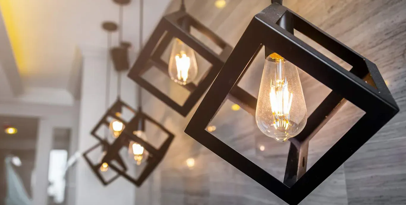 a group of pendant lights hanging from the ceiling in a room .