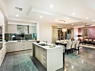 a kitchen and dining room in a house with a large island in the middle .