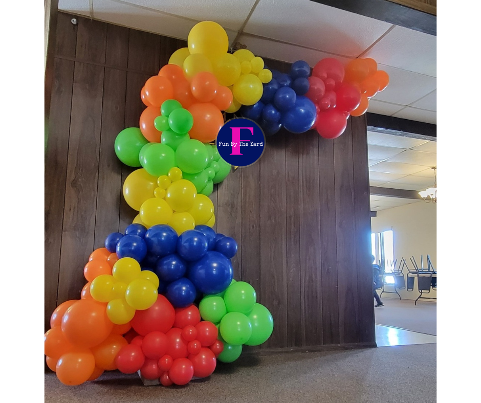 An organic balloon demi arch in rainbow colors