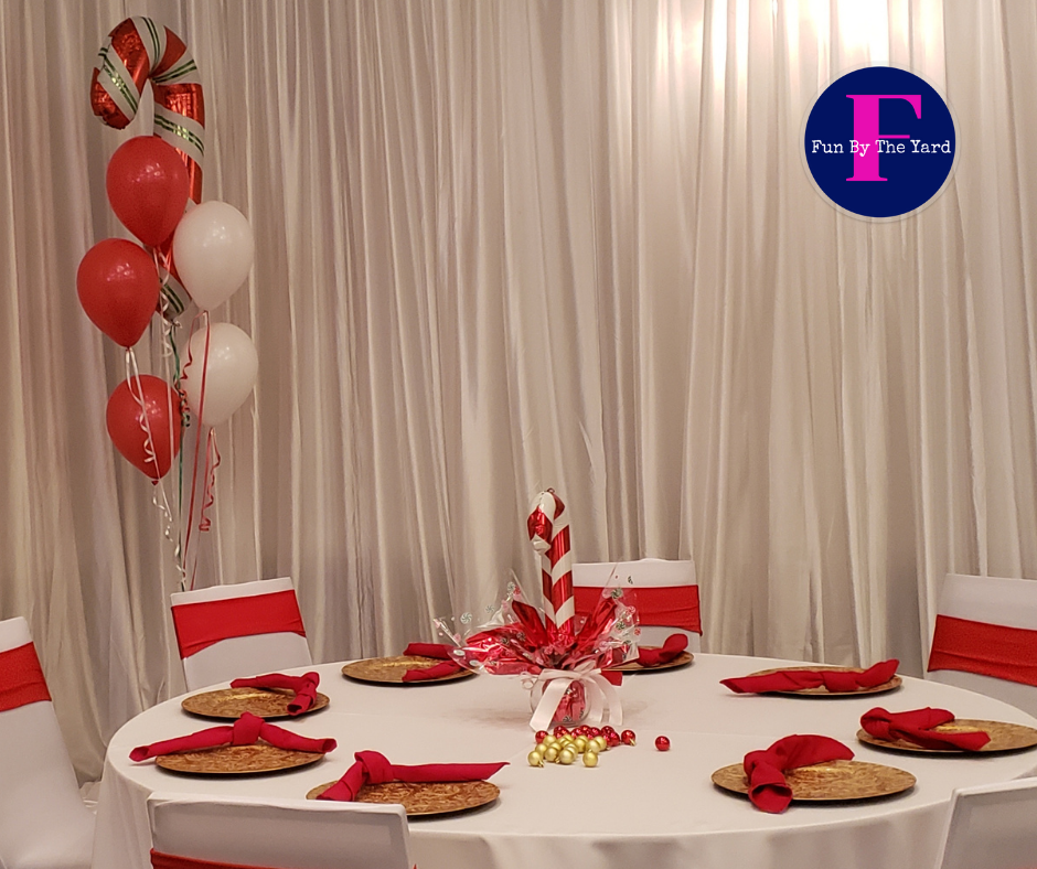 A table set up for a christmas party with candy canes and balloons