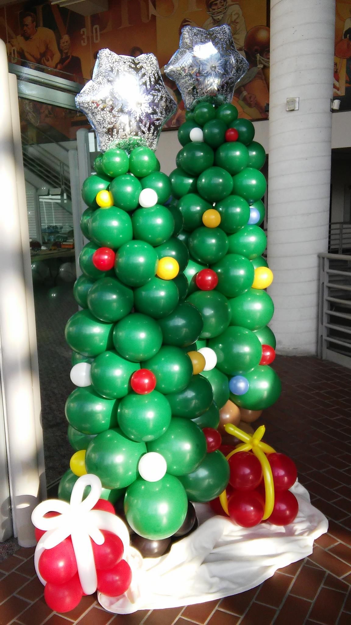 A christmas tree made out of green balloons