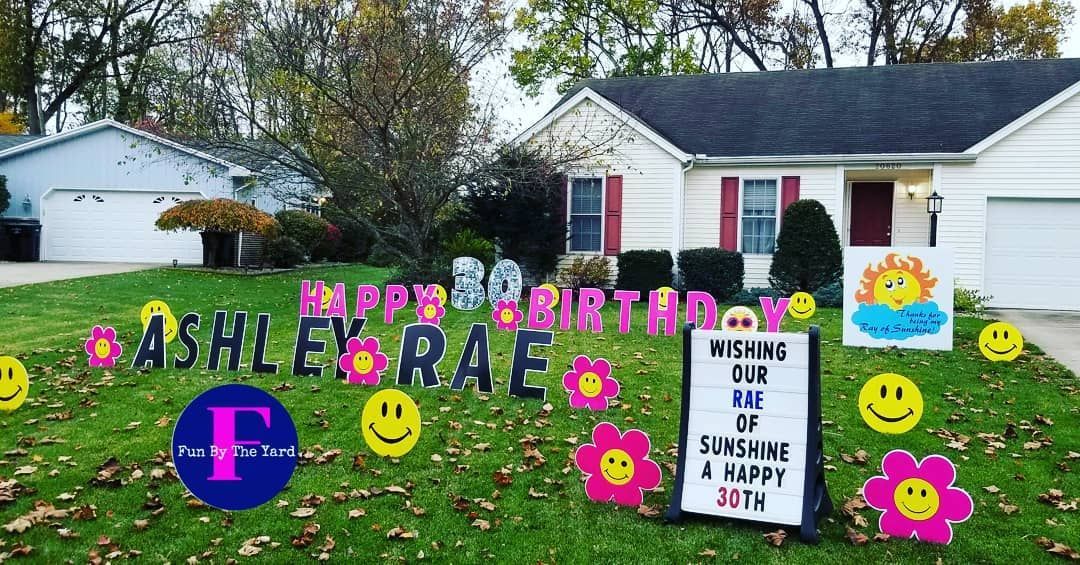 A house with a birthday sign in front of it.
